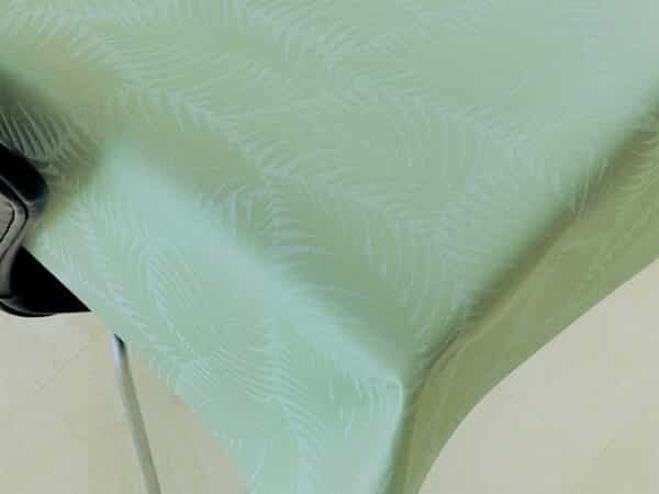 Akryl-/tekstildug med indfarvet bladmønster i olivengrøn, med antiskrid, 140 cm